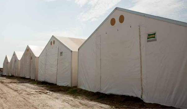 An image shows several erected Rubb Halls or mobile storage units 